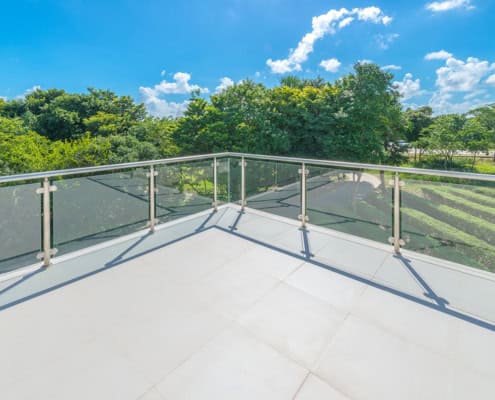 INNOVA compressed fibre cement flooring installed on an external balcony with glass balustrade