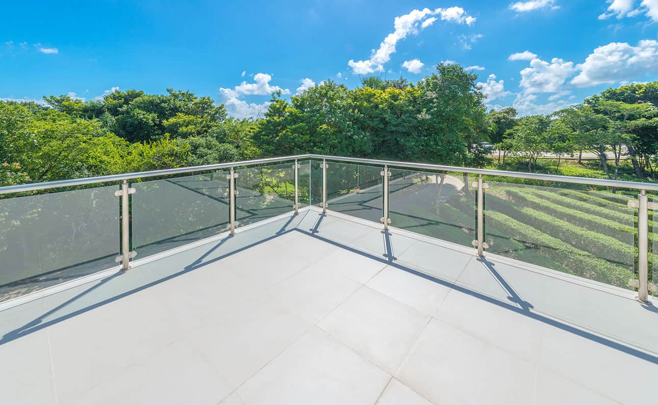 INNOVA compressed fibre cement flooring installed on an external balcony with glass balustrade