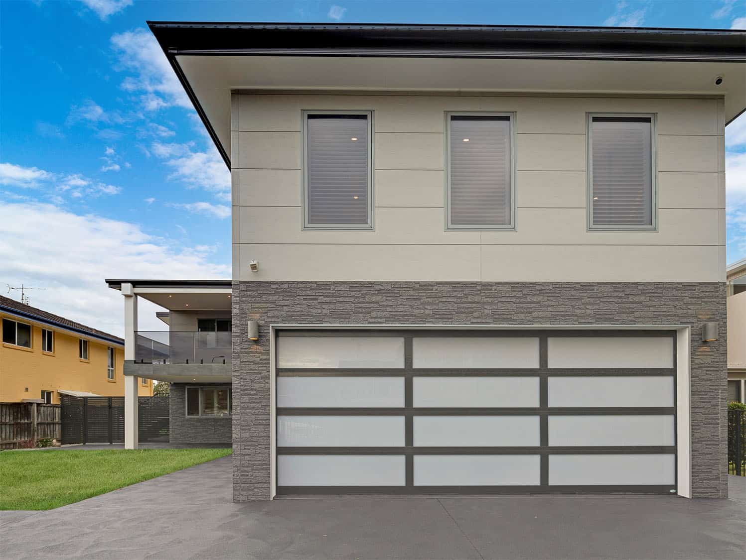 Modern home featuring INNOVA Montage® cladding in Concrete and Stackstone profiles, combining texture and clean lines for a durable, architectural finish.